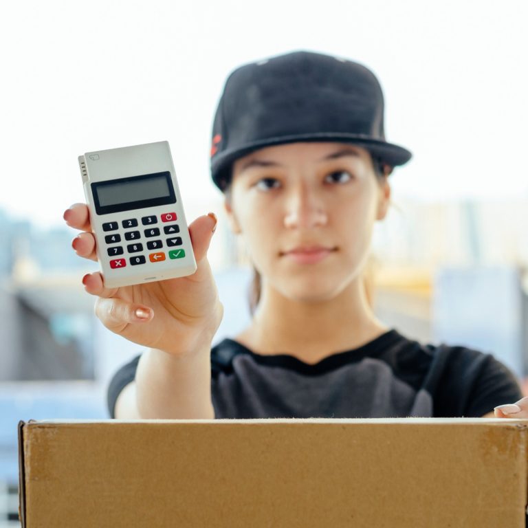 young-woman-holds-calculator-and-package-for-deliv-2026-09-22-09-54-14-utc